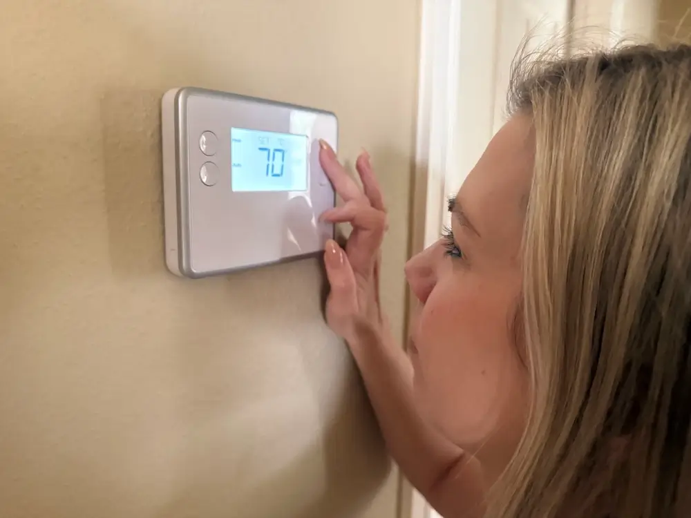 Image showing a person opening their fridge, because sleep deprivation increases the hunger hormone (ghrelin).