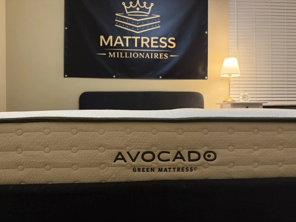 Side view of the Avocado Green Mattress showing its tufted cover and border