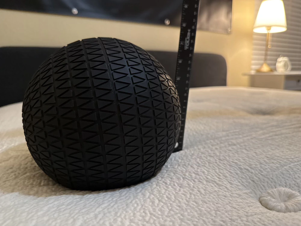 Weighted ball and ruler measuring sinkage on the Avocado Green mattress