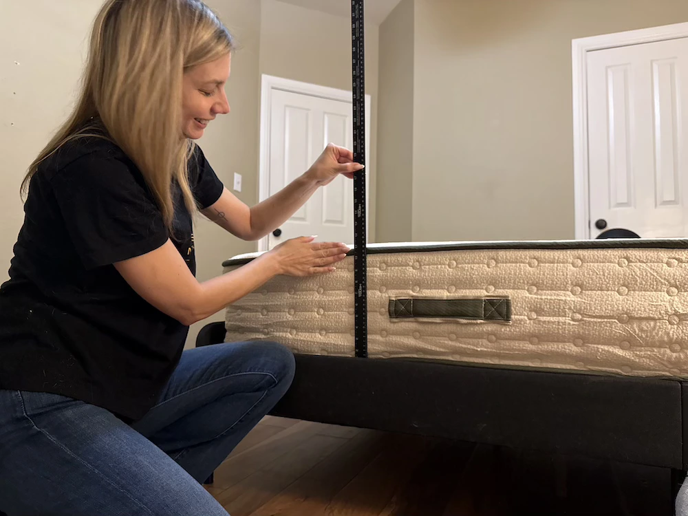 Measuring the height of the Avocado Green Medium mattress