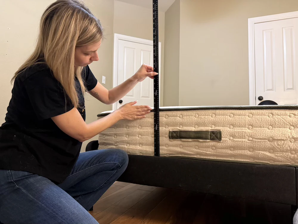 Measuring the height of the Avocado Green Medium mattress