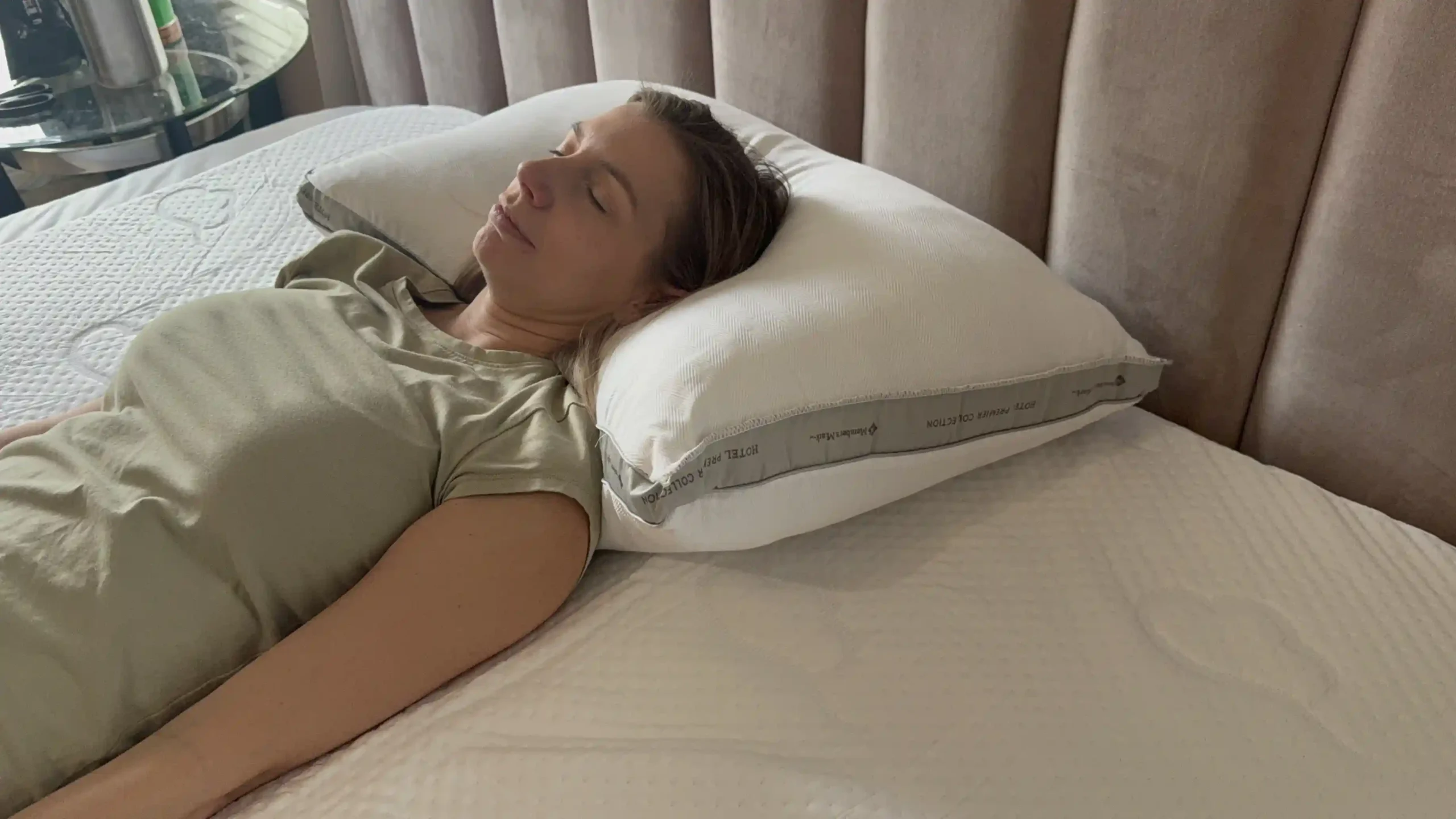 Adult lying on back with pillow support to represent healthy sleep habits and better sleep posture