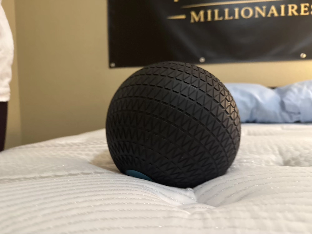 Weighted ball showing surface sinkage on the plush Bear Elite Hybrid mattress