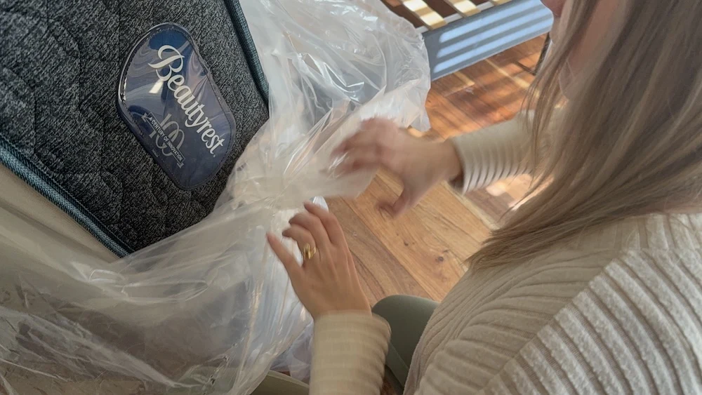 Unwrapping a Beautyrest Level One Medium mattress during setup
