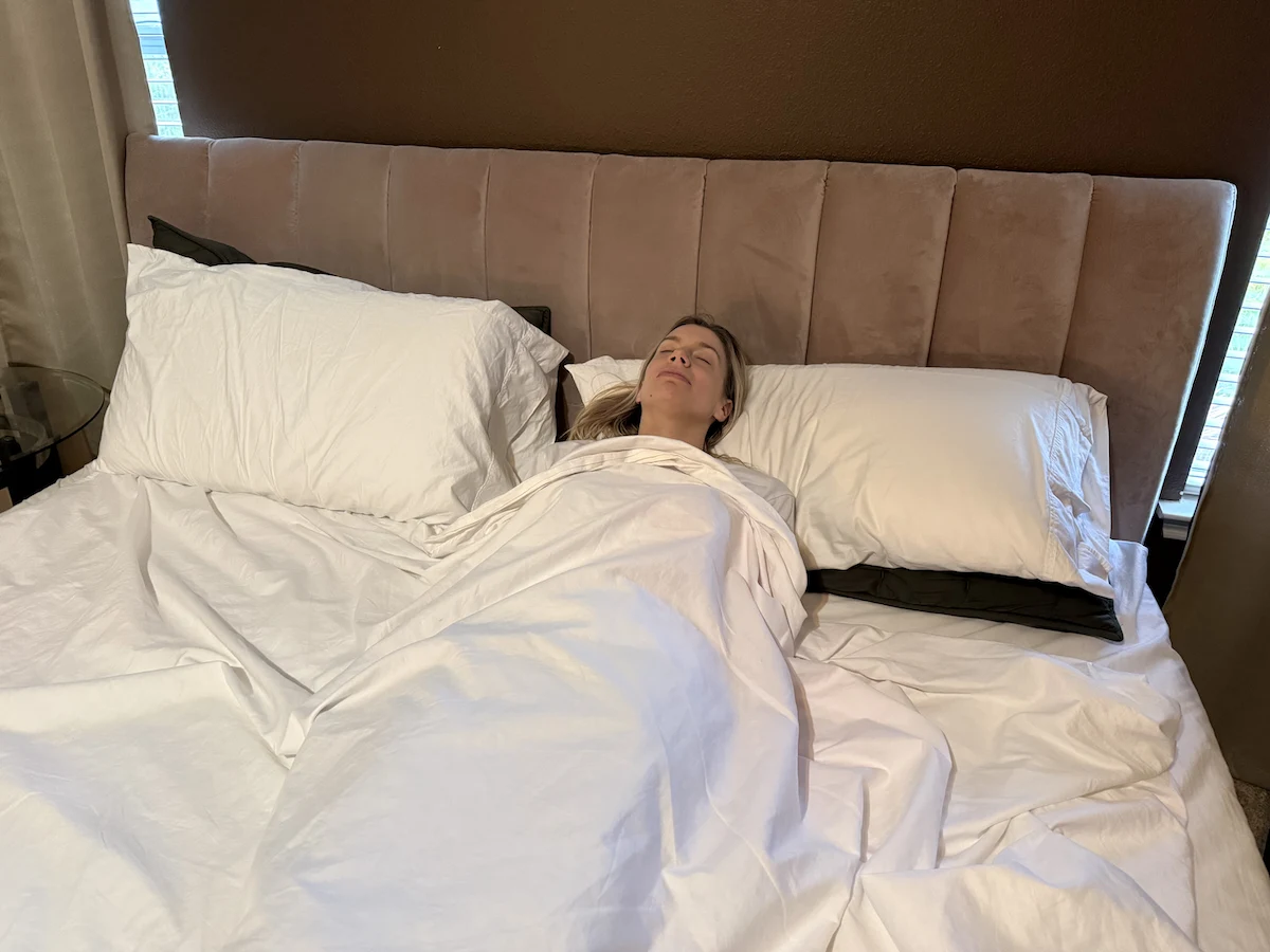 Woman resting peacefully in a bed designed for comfort and better sleep