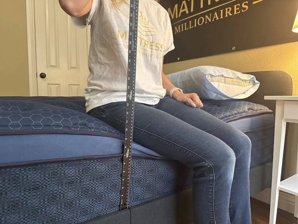 Measuring edge support on Brooklyn Bedding Signature Hybrid mattress showing compression depth