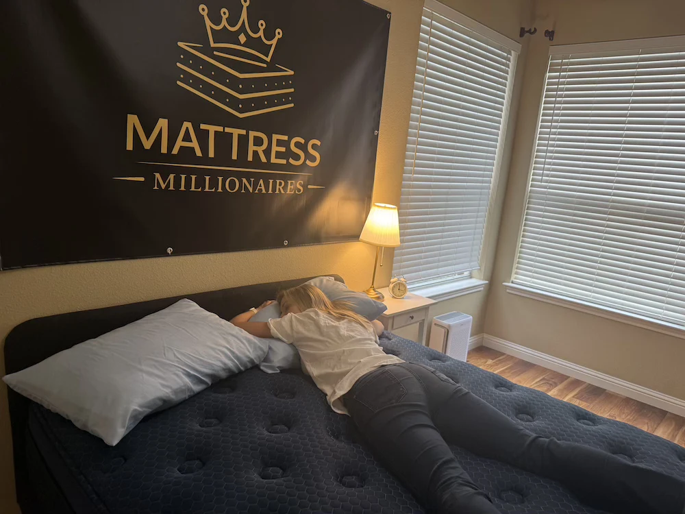 Stomach sleeping test on Brooklyn Bedding Signature Hybrid mattress showing spinal alignment and pressure relief