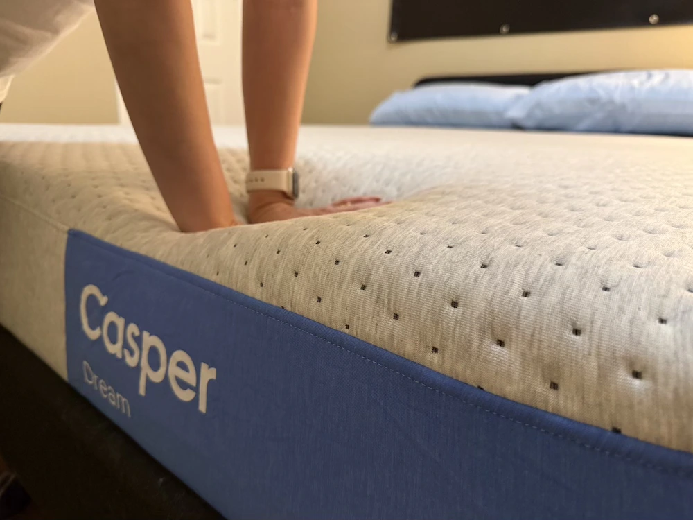 Hands pressing the Casper Dream foam comfort layer