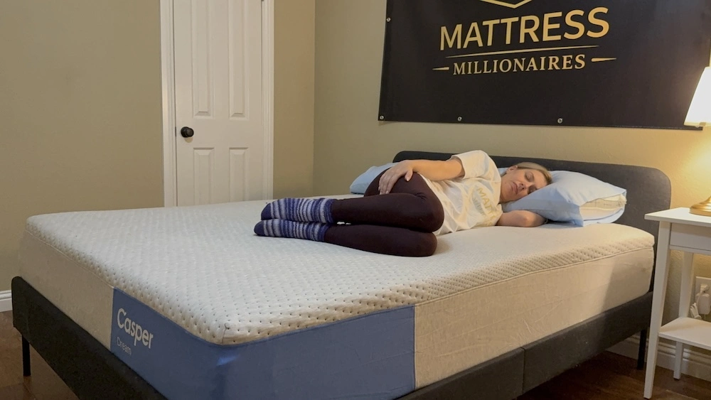 Side sleeper lying on the Casper Dream mattress after it finished expanding
