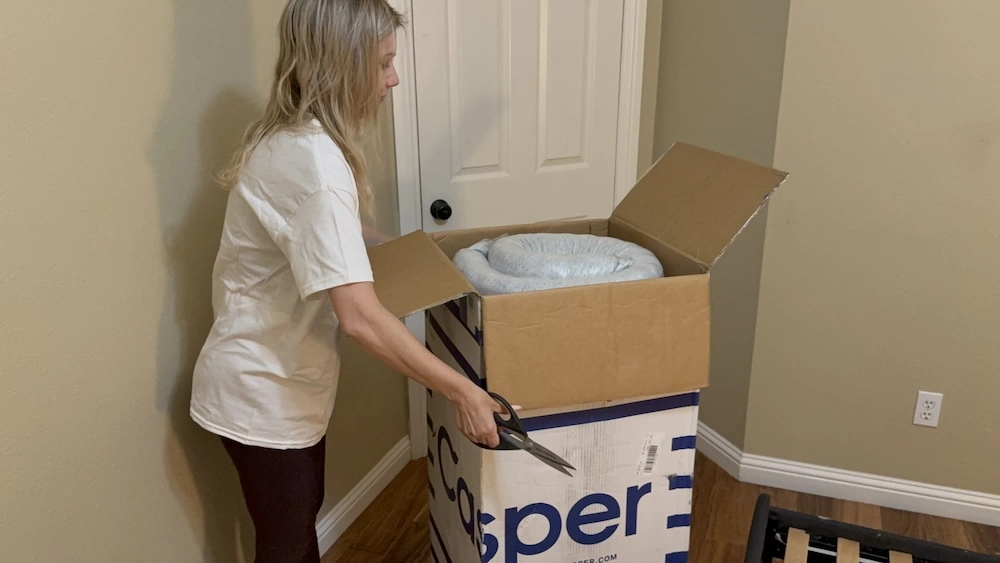 Opening the Casper Dream mattress box and removing the compressed mattress