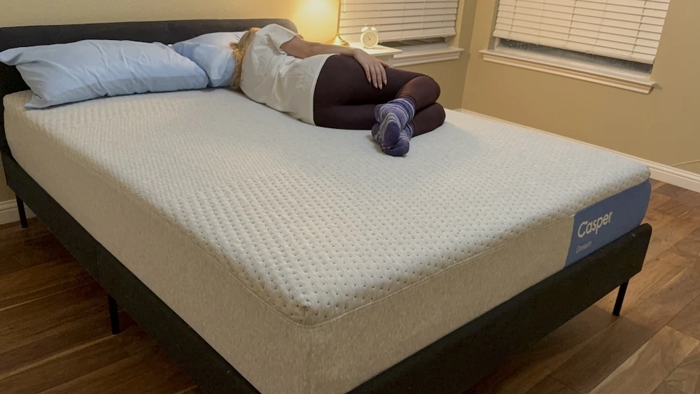 Full view of side sleeper testing the Casper Dream mattress