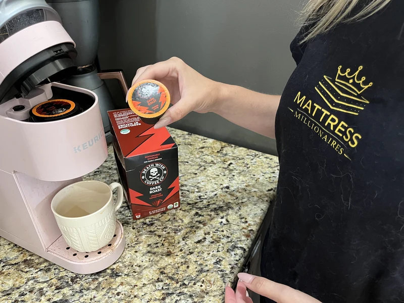 Coffee pod being prepared in a coffee maker, illustrating coffee as a potential acid reflux trigger.