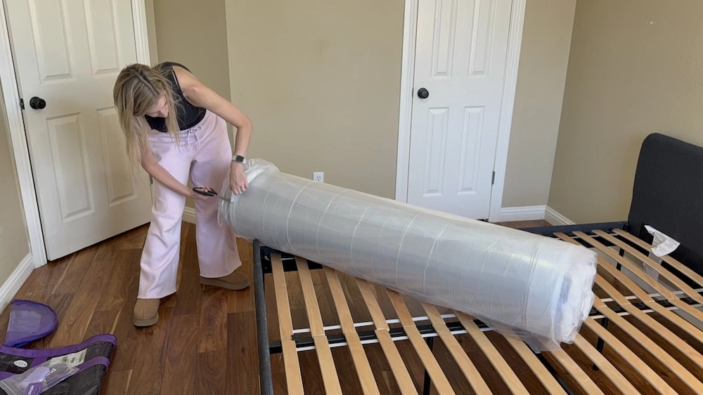 Cutting open Purple Plus mattress packaging during setup