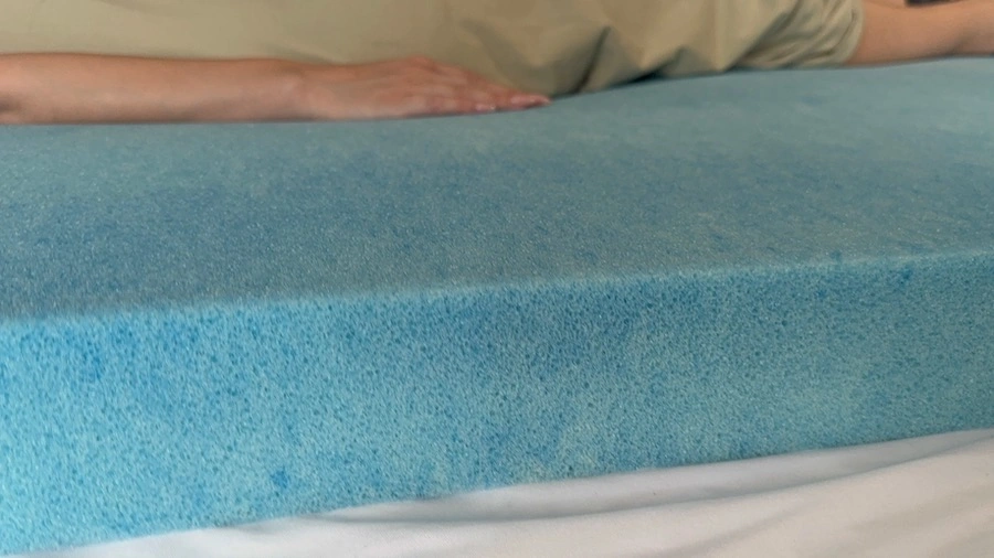 An image of a woman (side view) sleeping on a memory foam mattress.