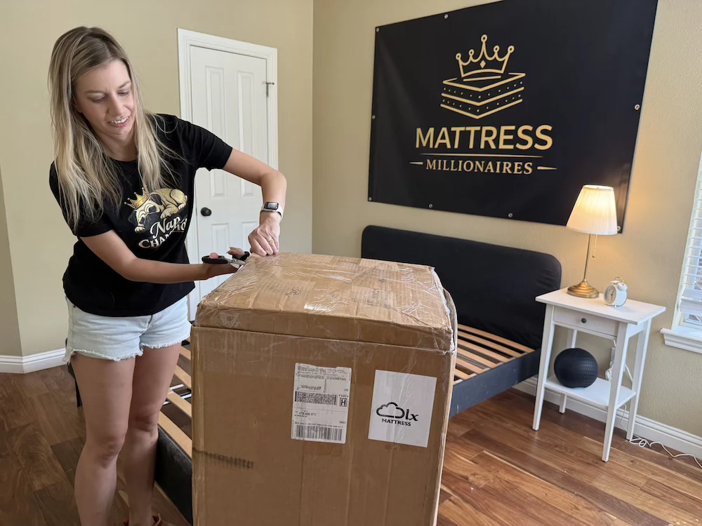 Tester opening the boxed DLX Premier Hybrid mattress before setup