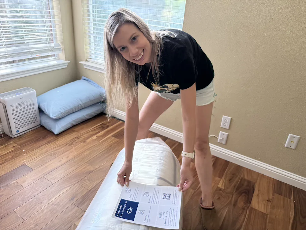 Tester holding the DLX Premier Hybrid setup information during unboxing