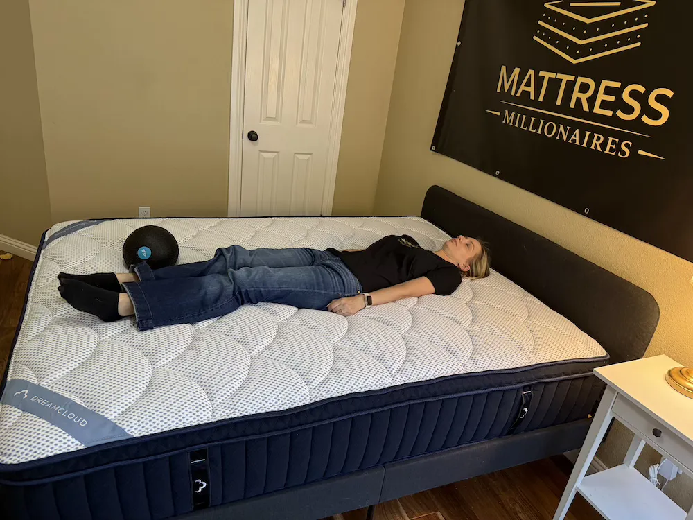 Back sleeper lying on the DreamCloud Premier mattress to test spinal alignment and support