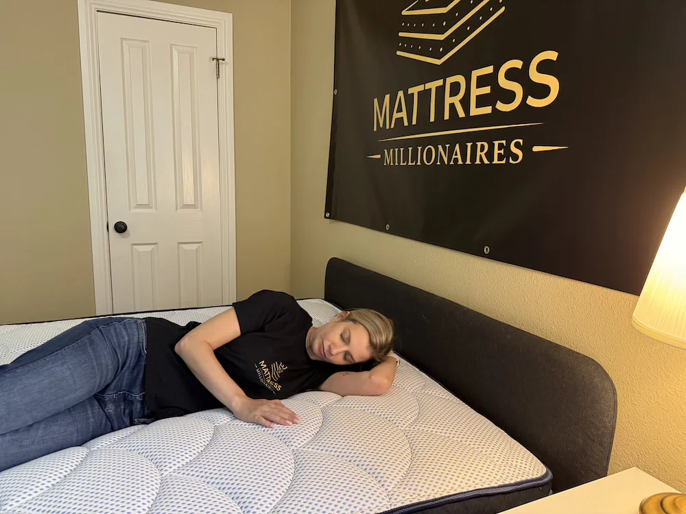 Side sleeper testing the DreamCloud Premier Hybrid mattress in a bedroom