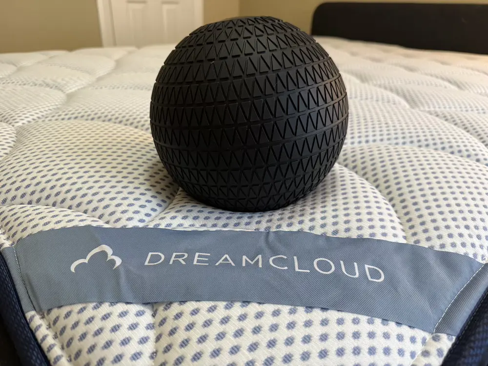 Weighted test ball resting on the DreamCloud Premier Hybrid Euro-top