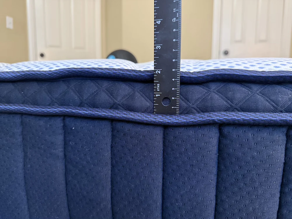 Measuring the height of the DreamCloud Premier pillow-top with a ruler