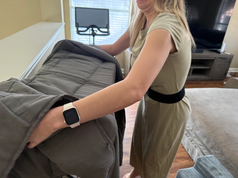 An image of a woman drying a weighted blanket.