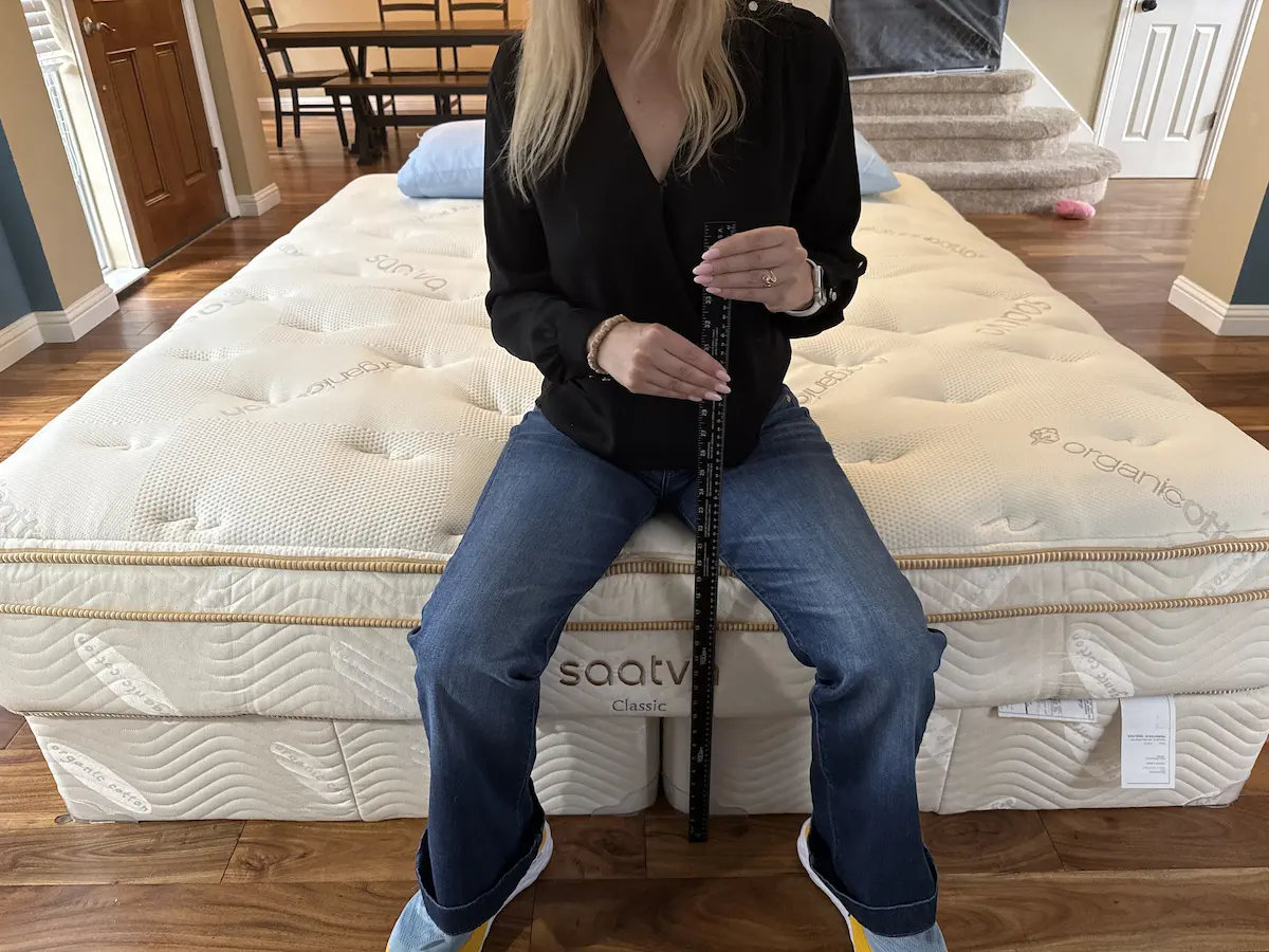 Image of a woman doing edge support testing for a mattress