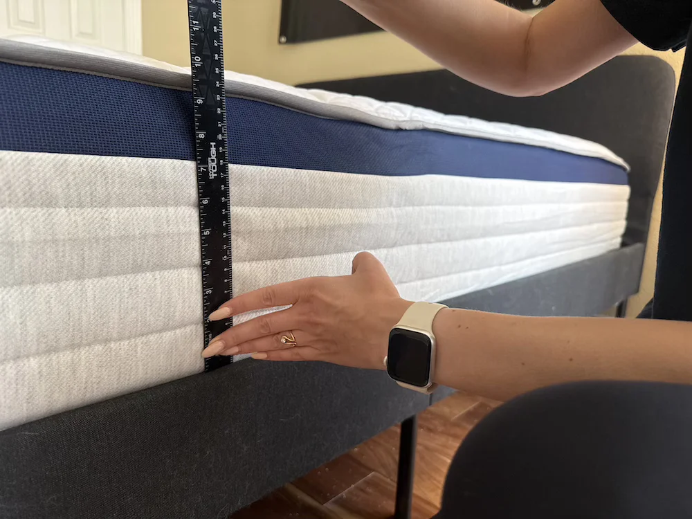 Measuring the 11.5-inch profile of the Helix Midnight mattress with a ruler