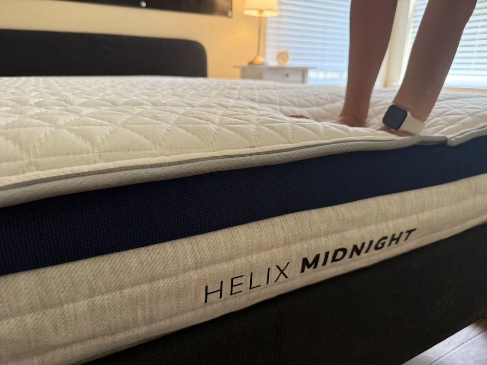 Close-up of the Helix Midnight edge during hands-on support and edge compression testing