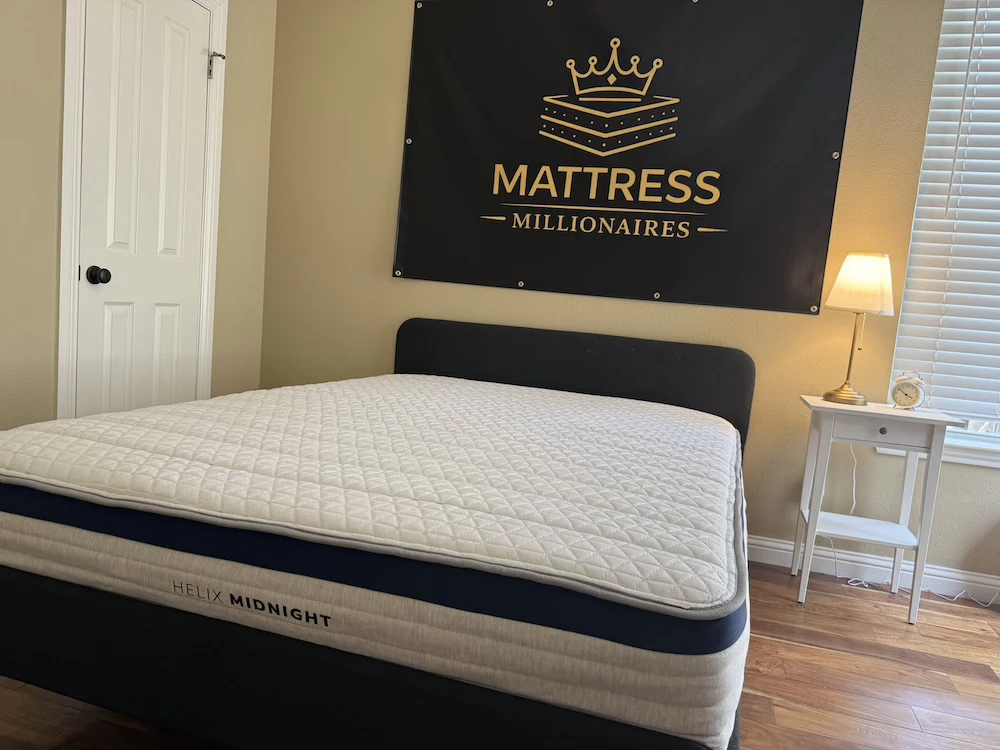 Full view of the Helix Midnight mattress on bed frame in bedroom