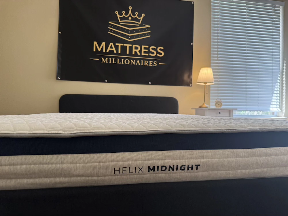 Helix Midnight mattress side profile showing the mattress height and branded label
