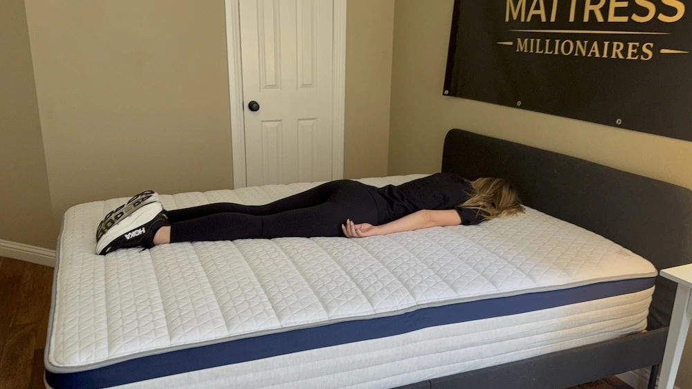 Stomach sleeper lying on the Helix Midnight mattress during support testing