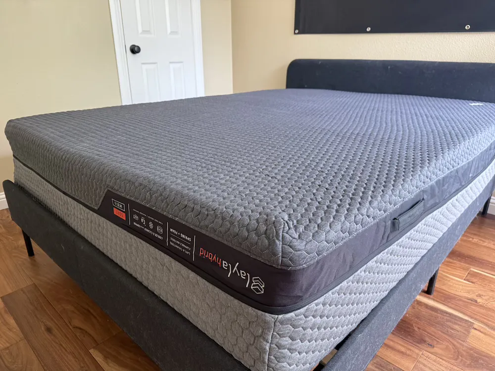 Layla Hybrid Flippable mattress shown on a bed frame in a bedroom