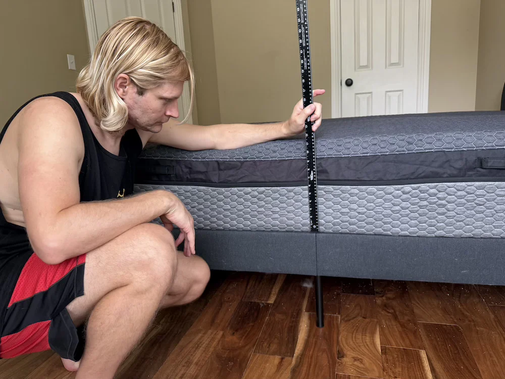 Measuring the height of the Layla Hybrid mattress with a ruler