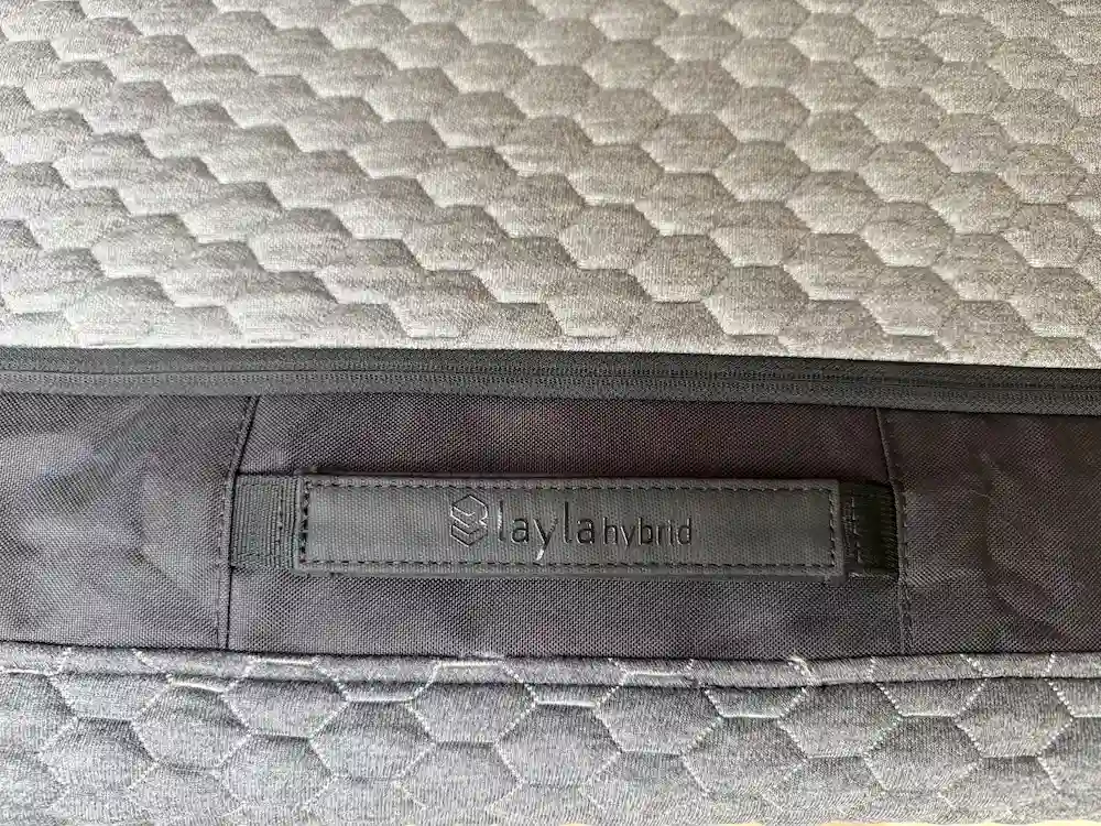 Close-up of the Layla Hybrid mattress label and side handle