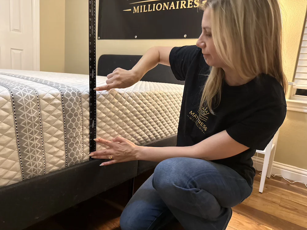 Measuring the height of the Leesa Sapira Hybrid mattress during testing