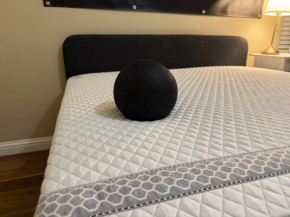 Weighted test ball on the Leesa Sapira Hybrid during in-home motion testing