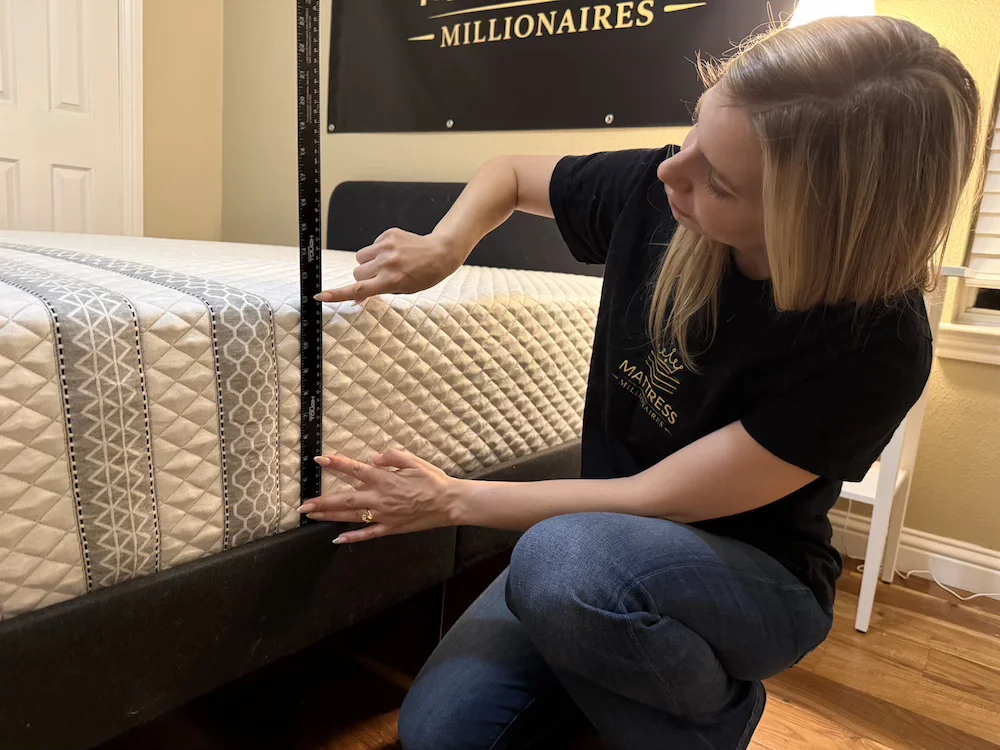 Measuring the 11-inch height of the Leesa Sapira Hybrid during hands-on testing