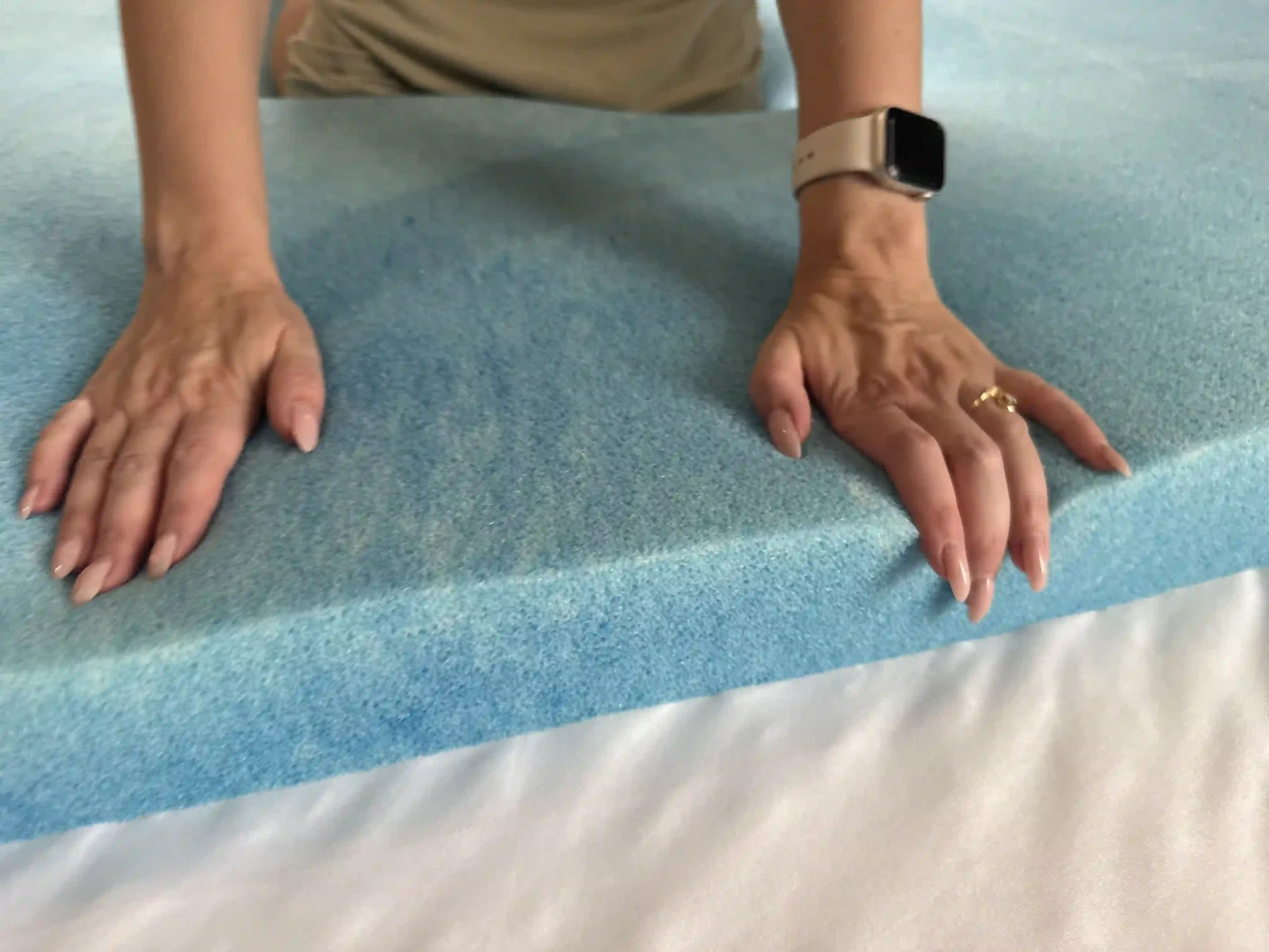Hands pressing into memory foam to show sinkage and reduced airflow