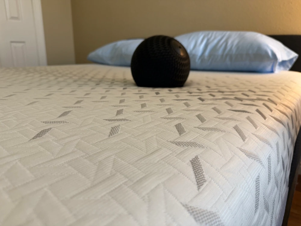An image of a medicine ball in the middle of a Nectar Premier mattress
