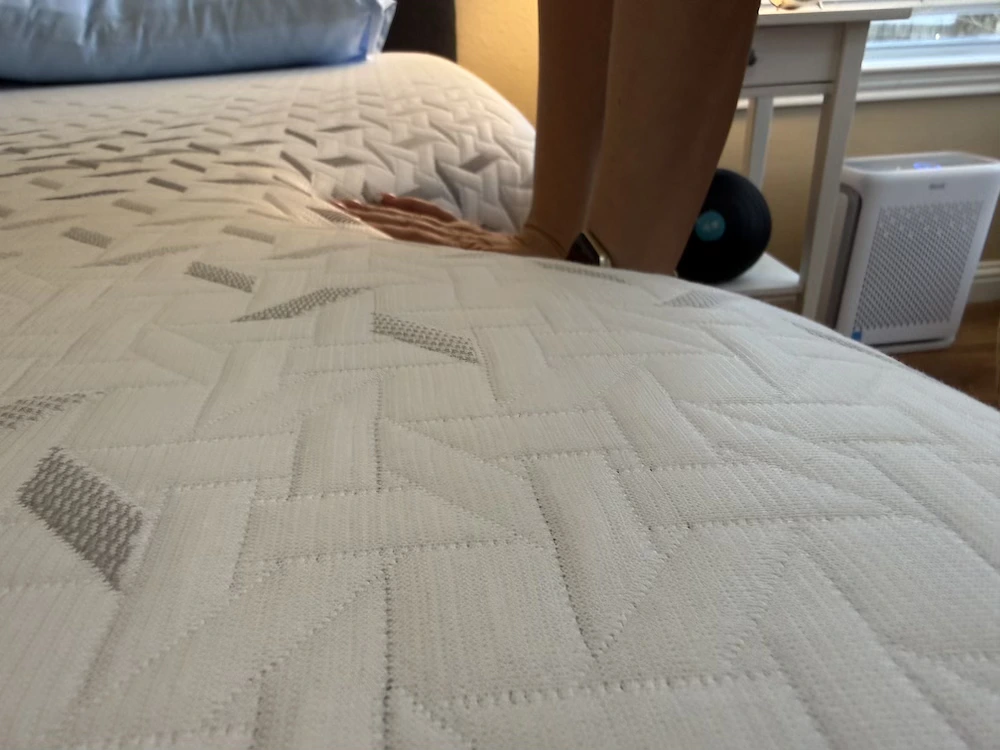 Pressing into Nectar Premier mattress edge showing foam compression and support