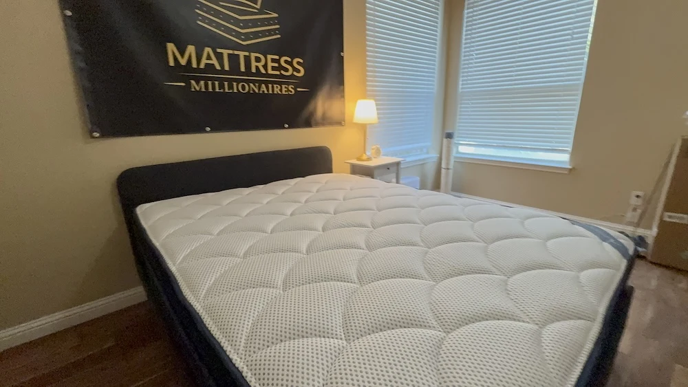 New mattress with smooth even surface on bed frame in bedroom