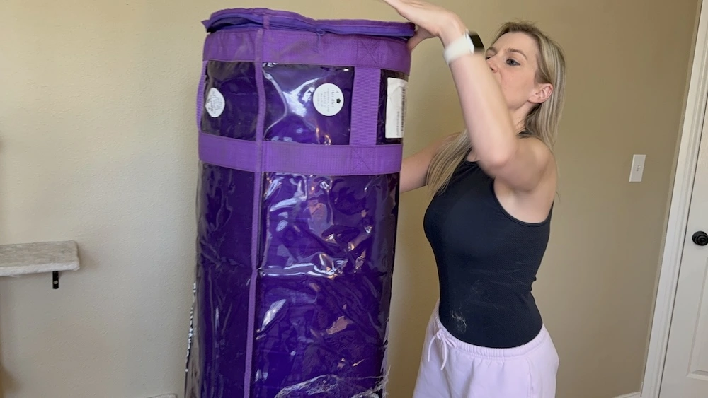 Opening rolled Purple Plus mattress before expansion