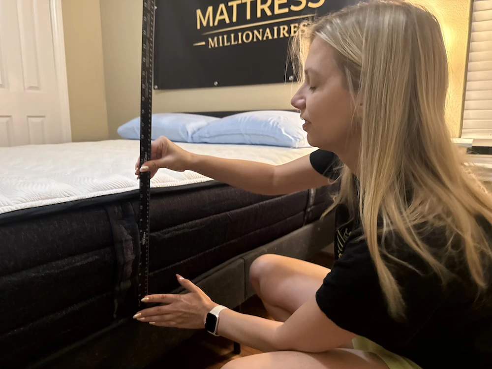 Mattress Millionaires tester measuring the height of the Origin Adapt Hybrid with a yardstick