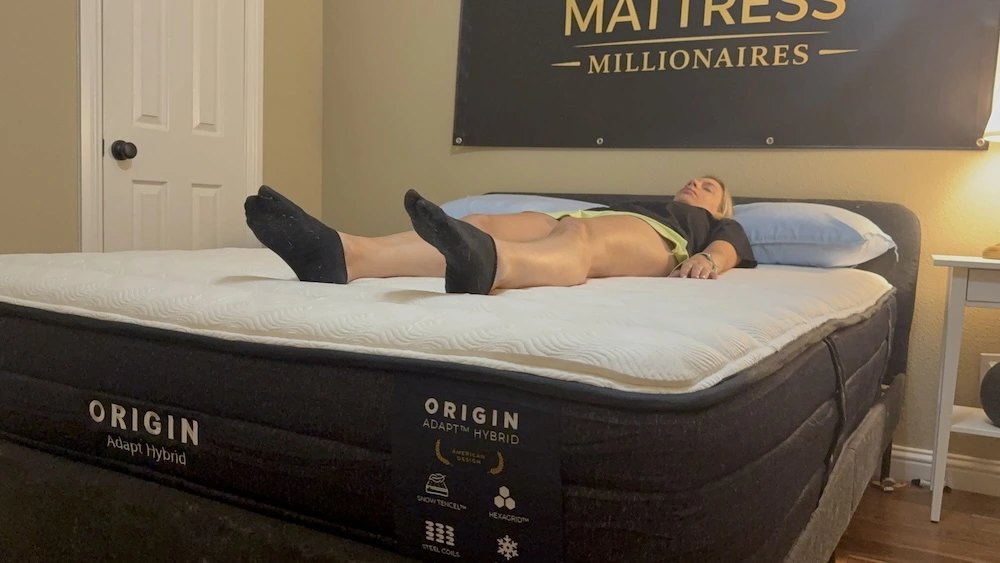 Mattress tester lying on her back on the Origin Adapt Hybrid during lumbar-support testing