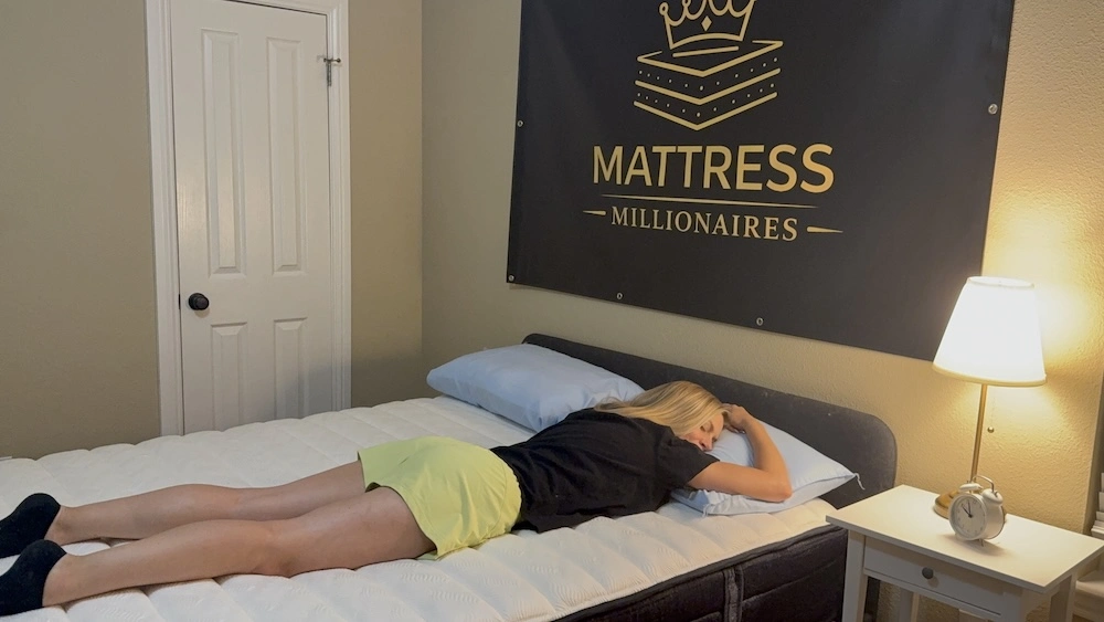 Mattress tester lying on her stomach on the Origin Adapt Hybrid during sleep-position testing