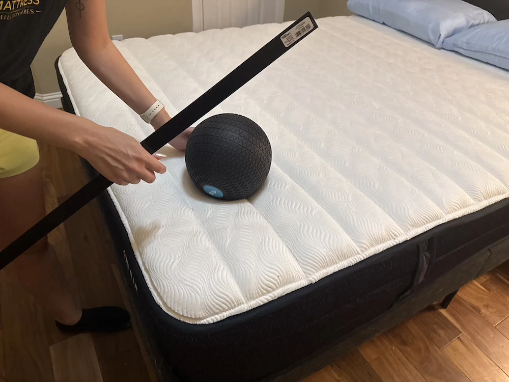 Weighted ball and yardstick used to test sinkage on the Origin Adapt Hybrid