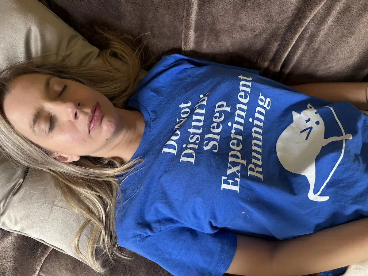 Person sleeping comfortably in a cool room while wearing a smartwatch