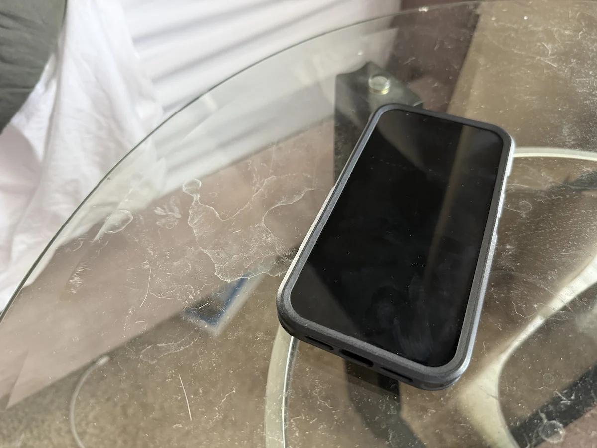 Smartphone resting on a table away from the bed