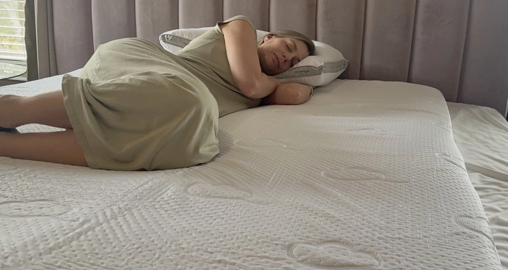 Side sleeping on the Puffy Deluxe Mattress Topper to evaluate shoulder pressure relief