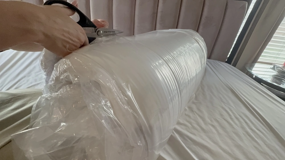 Removing the compressed Puffy Deluxe Mattress Topper from protective packaging
